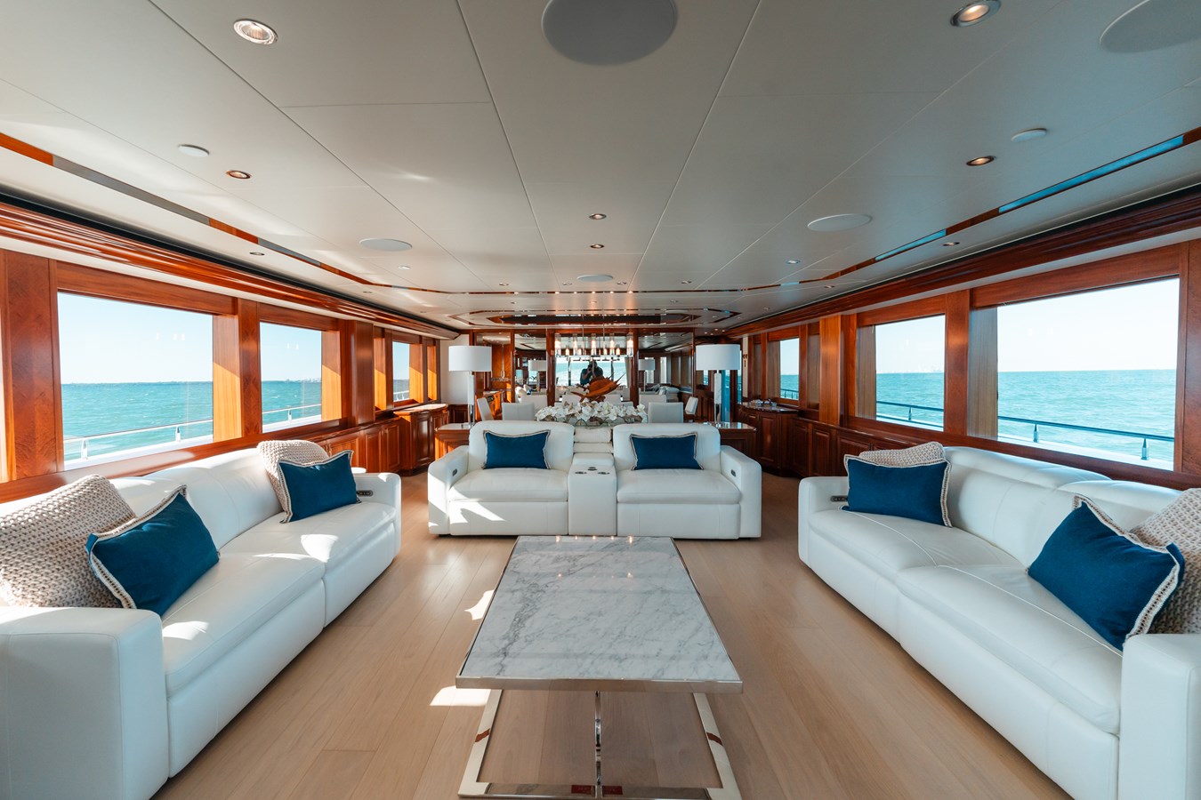 Westport 130 Blue Time main salon with white leather sofas and mahogany paneling