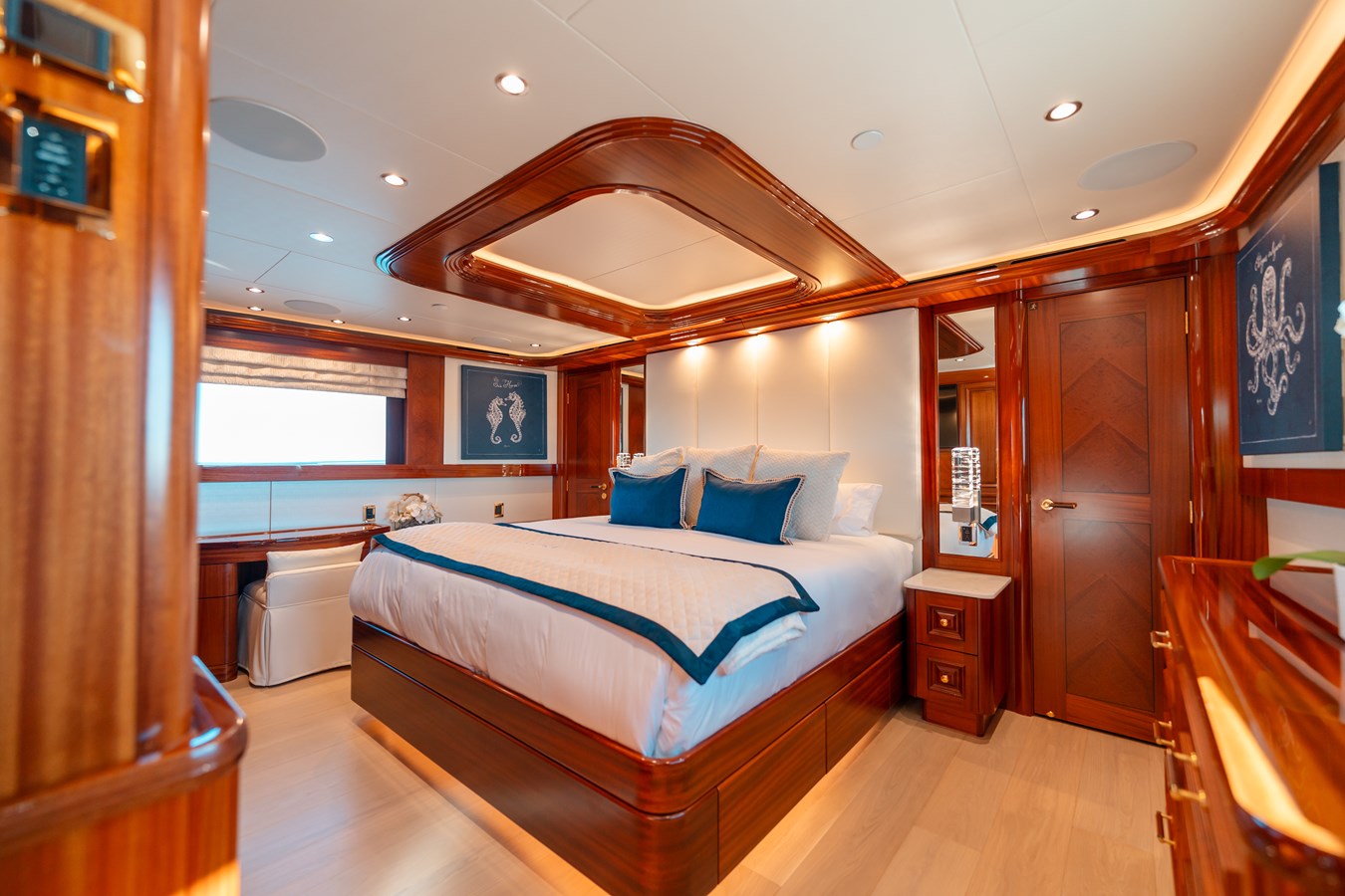 Westport 130 Blue Time master stateroom king bed with mahogany ceiling