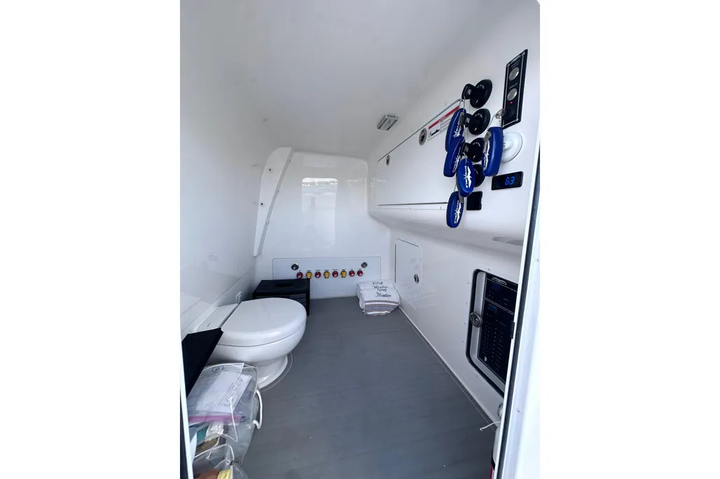 Invincible 40 Catamaran console head compartment with toilet and electronics panel
