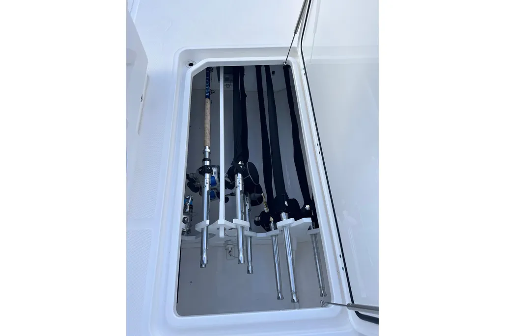 Invincible 40 Catamaran gunwale rod storage locker with fishing rods