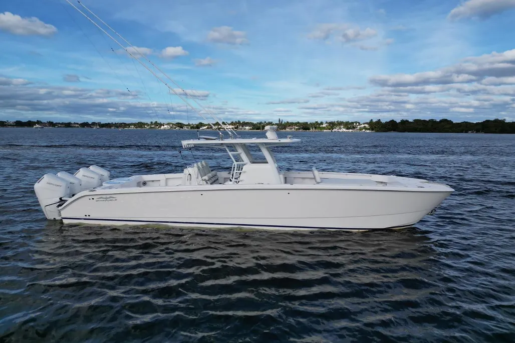 Invincible 40 Catamaran starboard profile at anchor with quad Mercury outboards