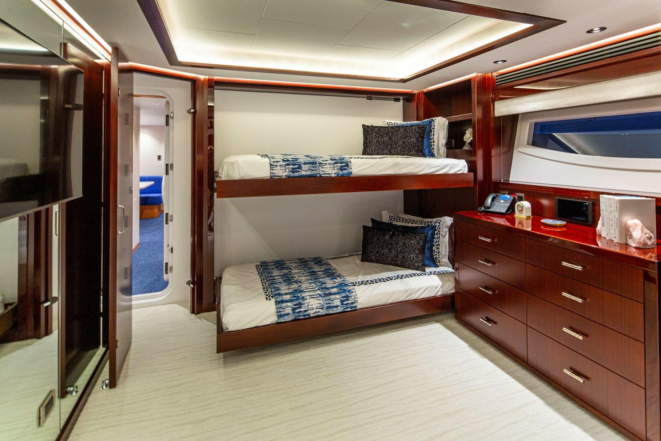 Guest cabin with upper and lower berths aboard Lion's Den, Westport 125