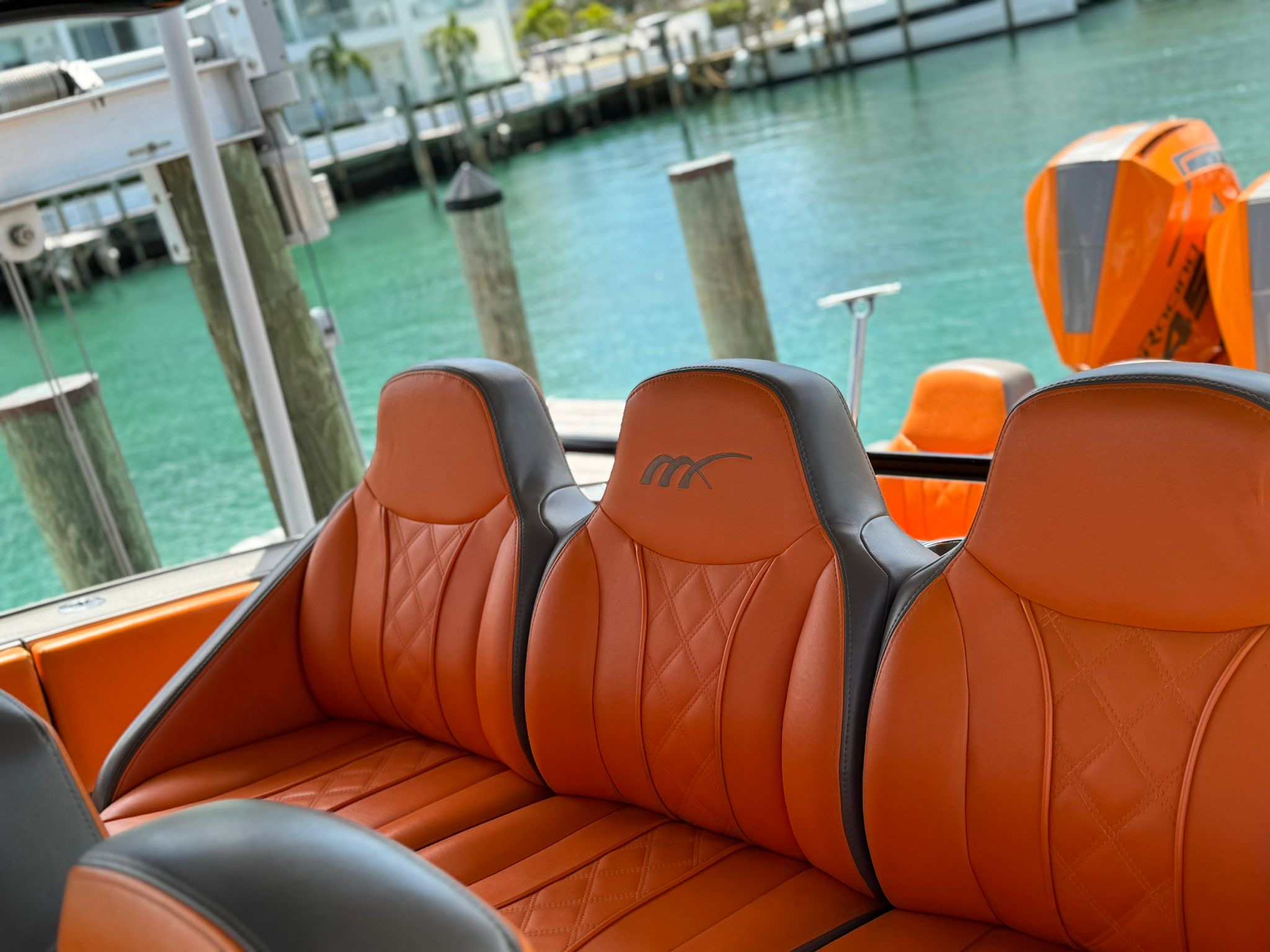 Midnight Express 43 Stop the Press close-up of rear helm seats with orange quilted upholstery