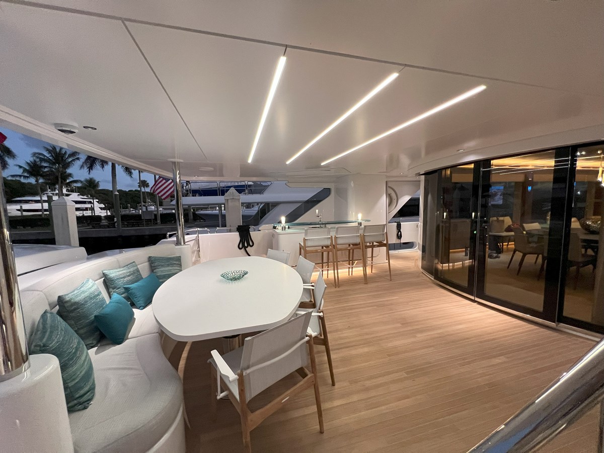 Westport W117 aft deck dining area with banquette seating at dusk