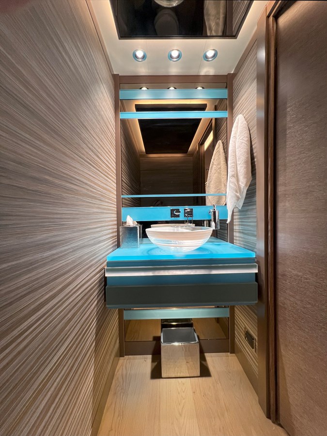 Westport W117 day head with turquoise glass vanity and textured walls