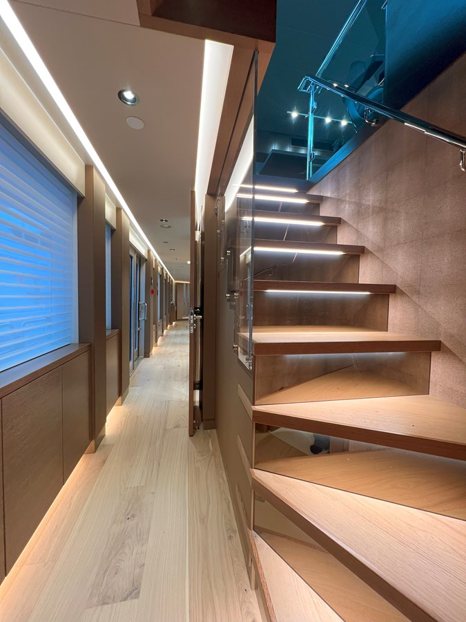 Westport W117 lower deck corridor with LED-lit staircase and glass balustrade