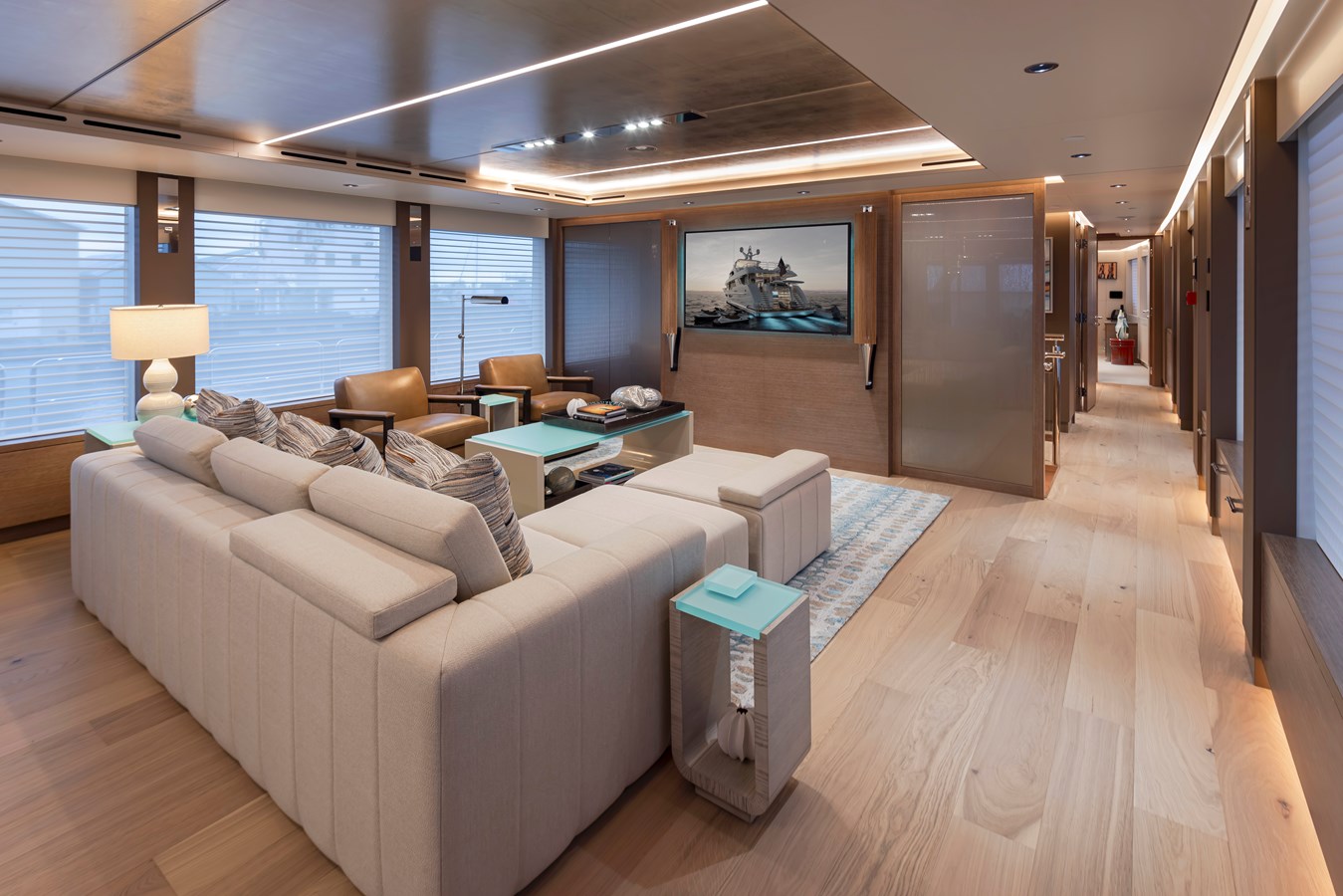 Westport W117 main salon with sectional sofa, leather chairs, and oak flooring