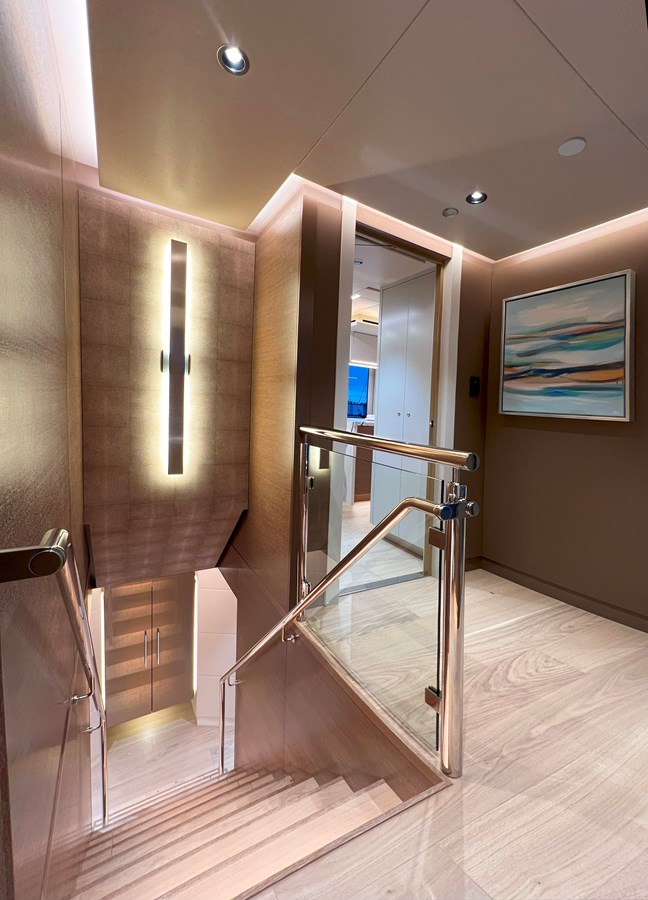 Westport W117 staircase landing with polished rails and abstract art