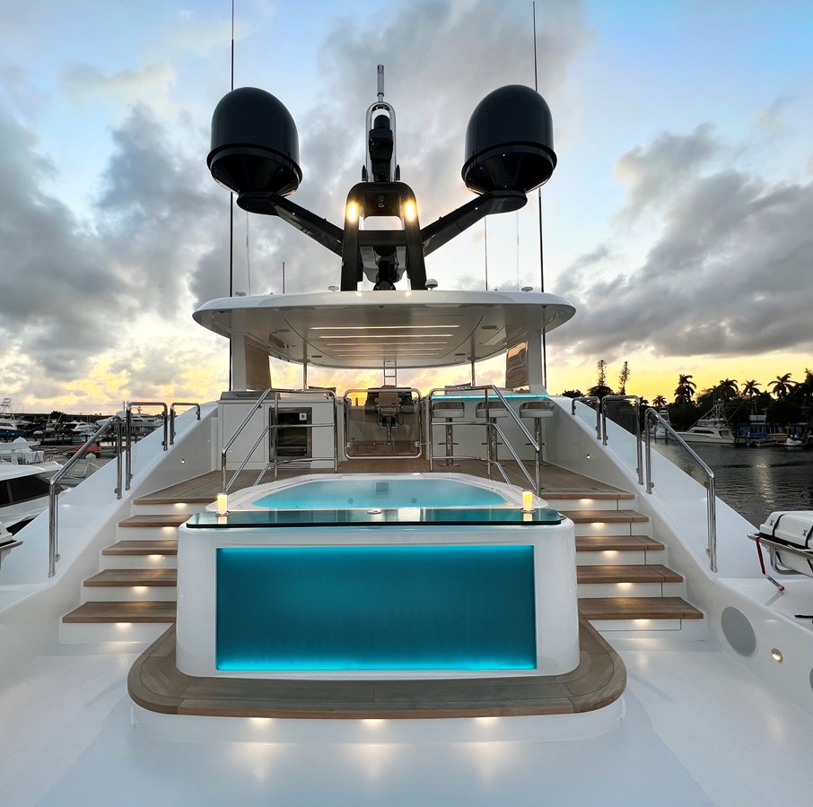 Westport W117 sundeck with glass-front jacuzzi and LED lighting at sunset